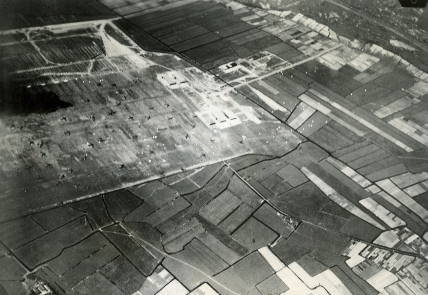 Aerial photograph of Valkenburg airfield on the morning of 10 May 1940, with dozens of landed German transport aircraft scattered across the field